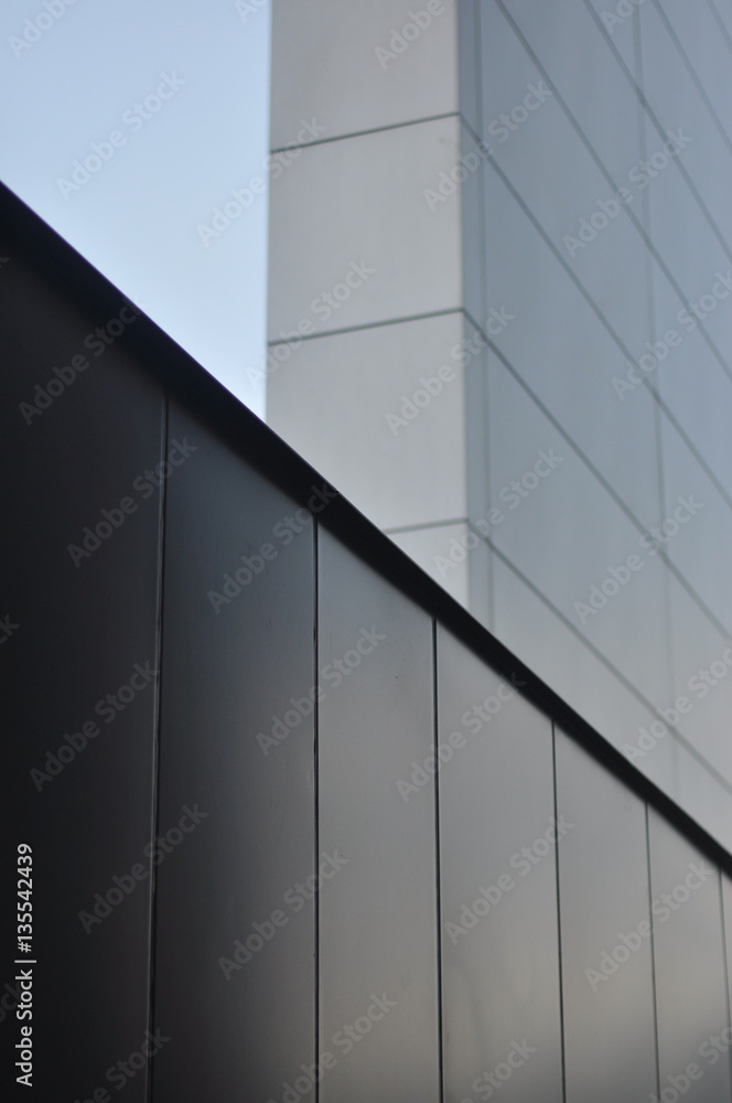 Fototapeta premium Architectural shot of aluminium horizontal element against silver cladding