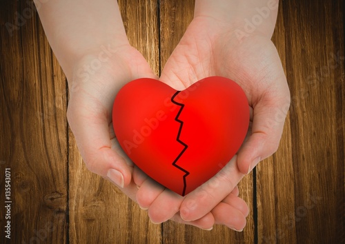 Broken heart in cupped hands