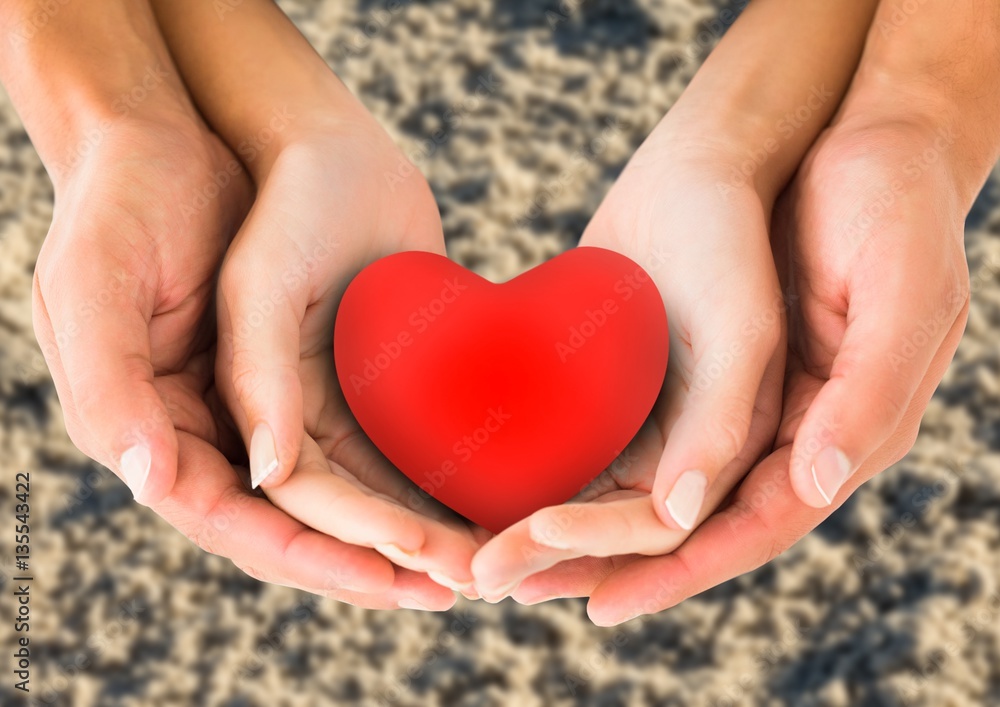Couple holding heart shape in cupped hands Couple holding heart shape in cupped hands