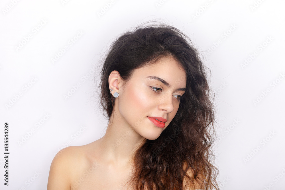 Beauty portrait of young adorable fresh looking brunette woman with healthy curly hair half closed eyes looking down. Emotion and facial expression concept. Beauty portrait of young adorable fresh looking brunette woman with healthy curly hair half closed eyes looking down. Emotion and facial expression concept.