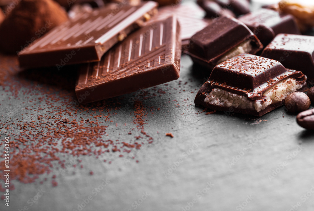 Delicious chocolates and spices on a black background. Delicious chocolates and spices on a black background.
