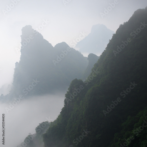 Photo of Huge Rock Mountain Silhouette with White Mist. Epic Mountain Landscape