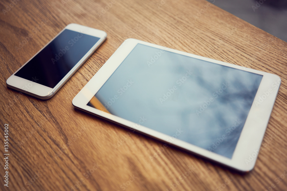 Smartphone and digital tablet on wooden desk Smartphone and digital tablet on wooden desk