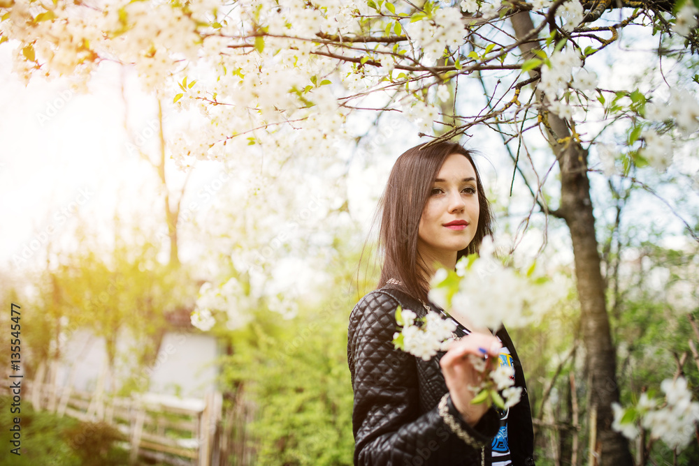 Close up portrait of young brunette girl with cherry blossom at Close up portrait of young brunette girl with cherry blossom at