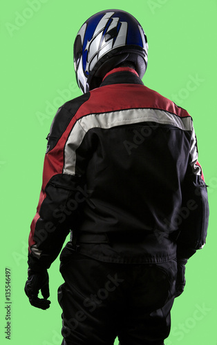 Male wearing protective leather and textile suit for racing race cars or motorcycles.  The armor is worn in professional motor sports.  The man is on a green screen or chroma key background.
