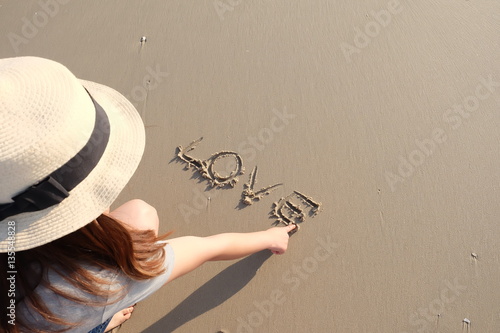 Woman writing the word 