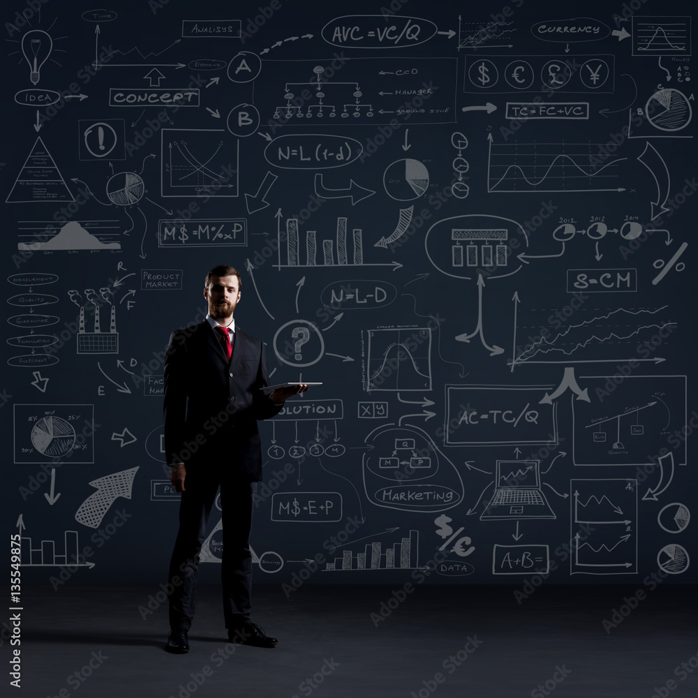 Businessman with a tablet gadget. Black background with copyspac Businessman with a tablet gadget. Black background with copyspac