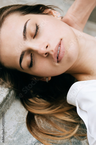 Outdoors portrait of beautiful young sensual woman with eyes closed. sleep concept