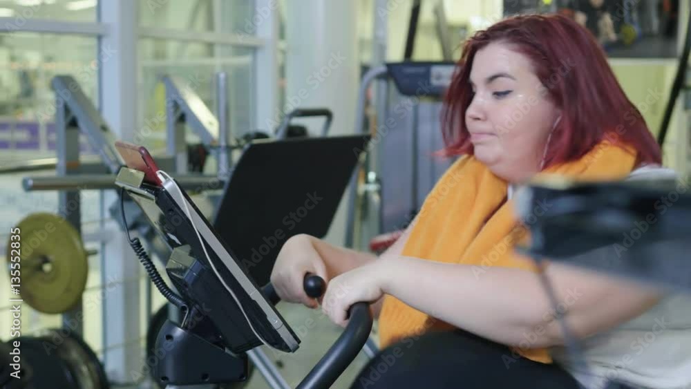 full woman practicing on the bike in the fitness Studio full woman practicing on the bike in the fitness Studio