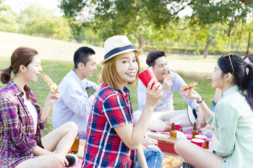 happy young friends enjoying healthy picnic