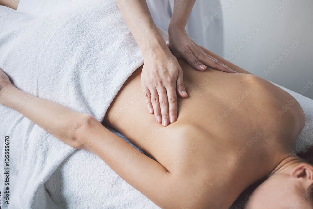 Young woman relaxing with hand massage at beauty spa. Young woman relaxing with hand massage at beauty spa.