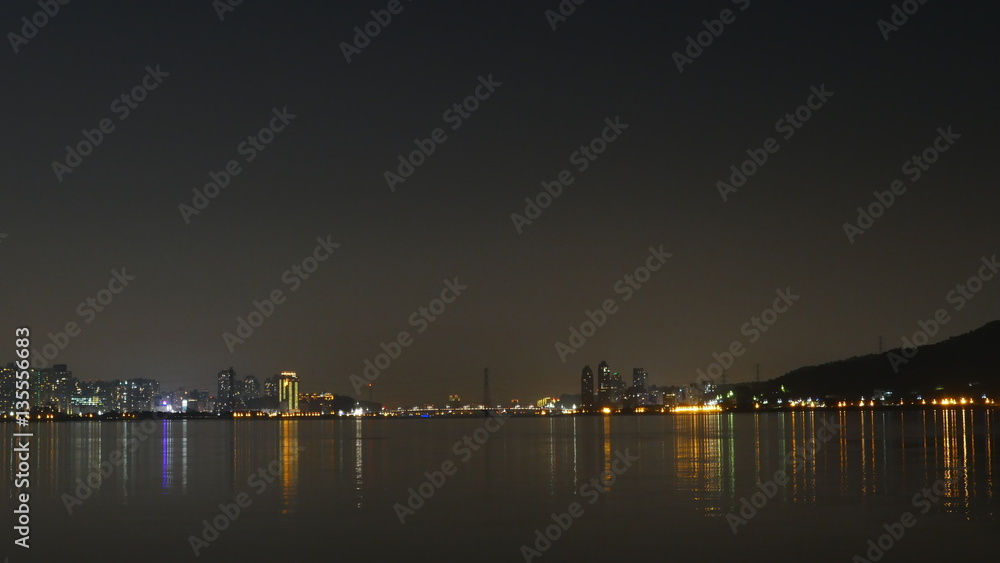 Tamsui river with view on bridge and Bali district at night