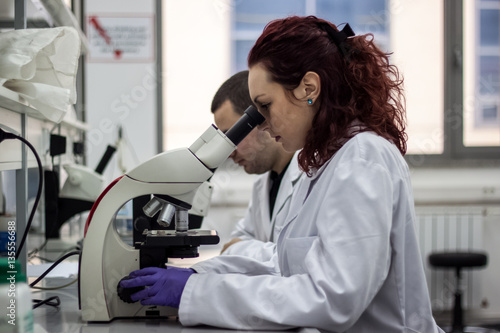 A female medical or scientific researcher or woman doctor lookin