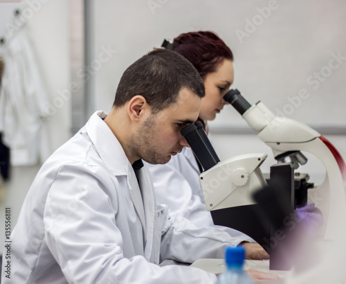 Female and male medical or scientific researchers or women and m
