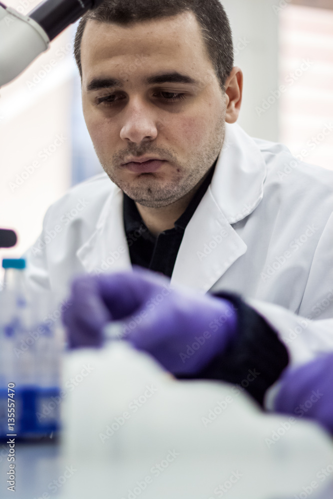 Young doctor performs tests and lab wearing a white coat Young doctor performs tests and lab wearing a white coat