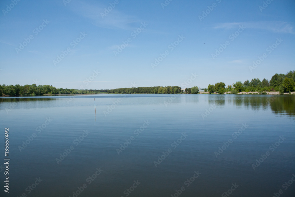 Beautiful summer landscape with river Southern Bug and blue sky in Vinnitsa, Ukraine. Calm summer day on river,sunny image.River on background of trees and sky.river and forest