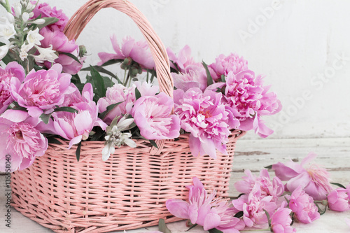 pink peony in basket on old white background