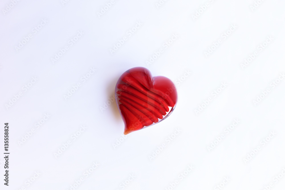 red glass heart on white background