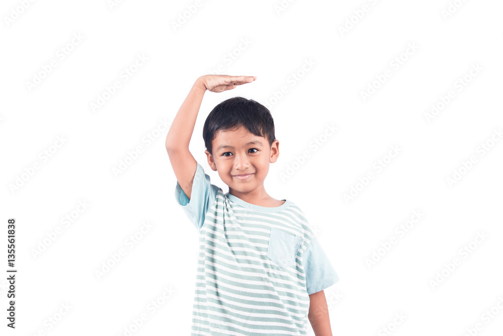 cute boy measures his height with his hand on the head cute boy measures his height with his hand on the head