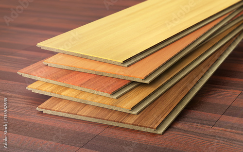 Stack of wooden laminate parquet on a wooden blur background. 3d