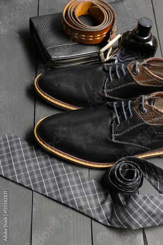 shoes and accessories for men lay on the wooden floor