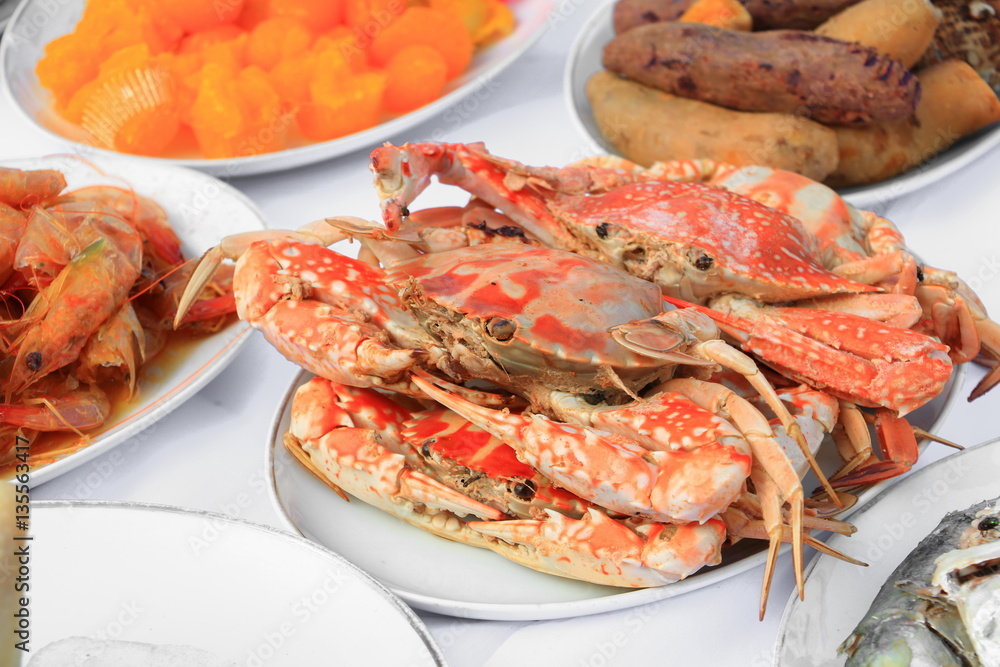 Steamed crab close up on plate and food many in home party Steamed crab close up on plate and food many in home party