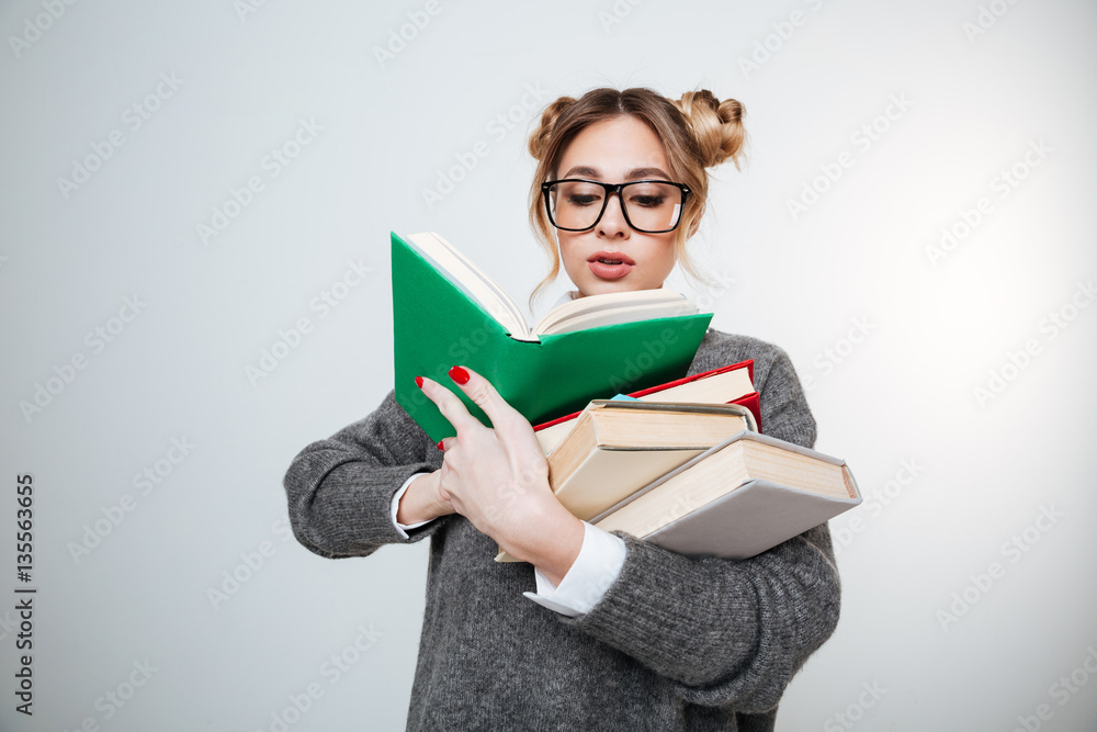 Woman in sweater and eyeglasses holding books Woman in sweater and eyeglasses holding books