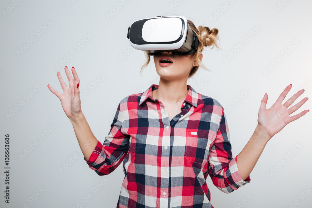 Woman in shirt using virtual reality device Woman in shirt using virtual reality device