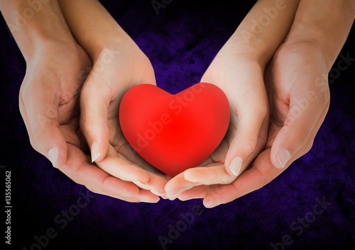 Hands of couple holding a heart