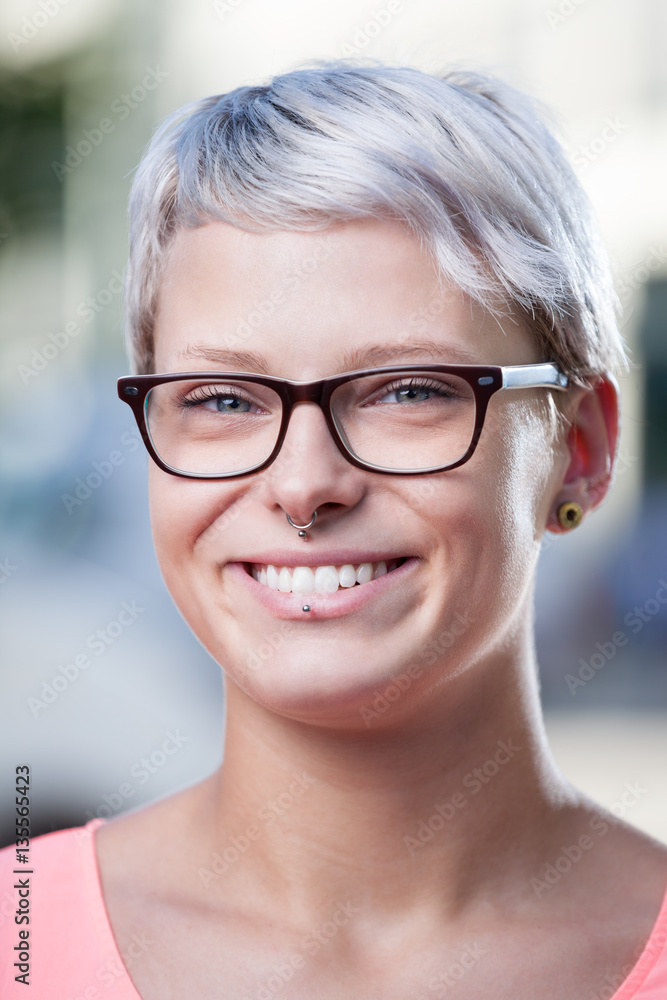 trendy woman with glasses and piercings