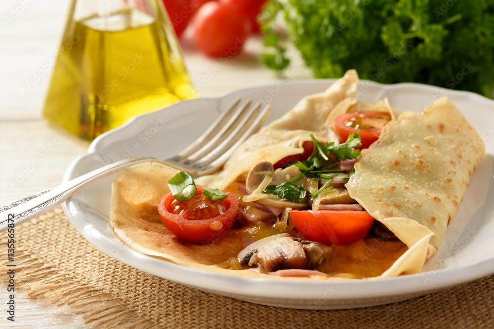 Pancakes sutffed with ham, cheese, tomatoes and mushrooms. Pancakes sutffed with ham, cheese, tomatoes and mushrooms.
