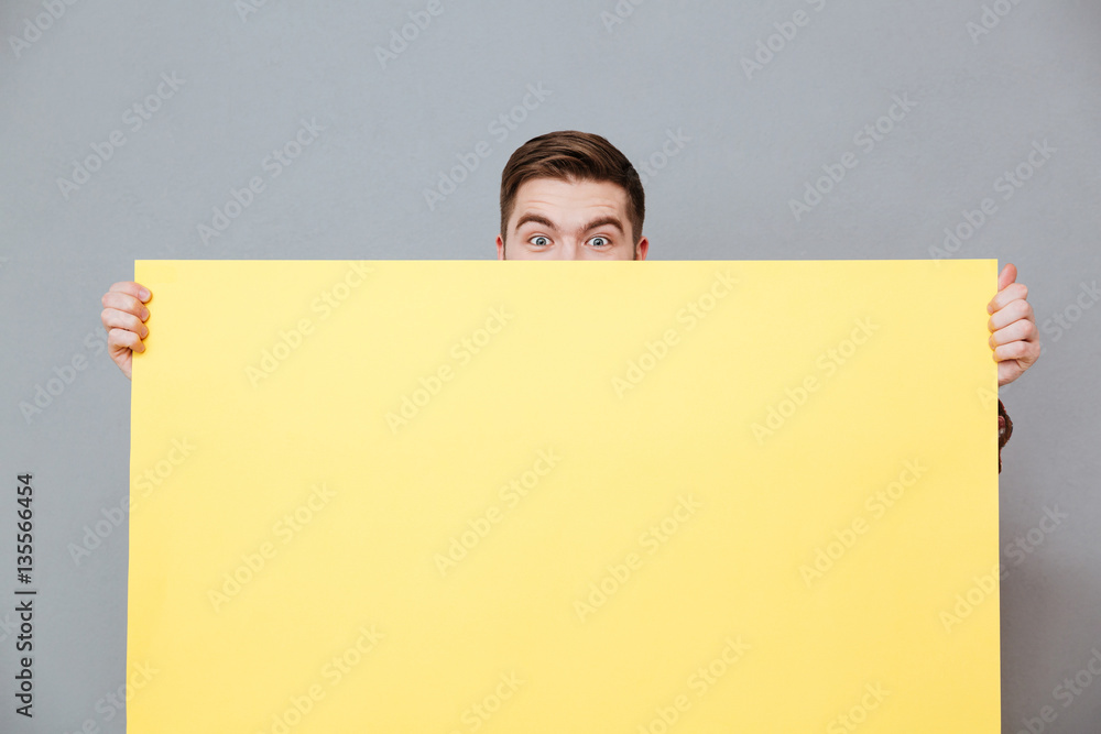 Attractive bearded man holding copyspace board Attractive bearded man holding copyspace board