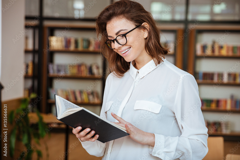 Happy student girl or young woman in eyeglasses with book Happy student girl or young woman in eyeglasses with book