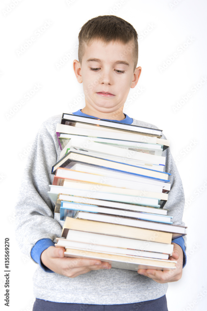boy holding pile of books