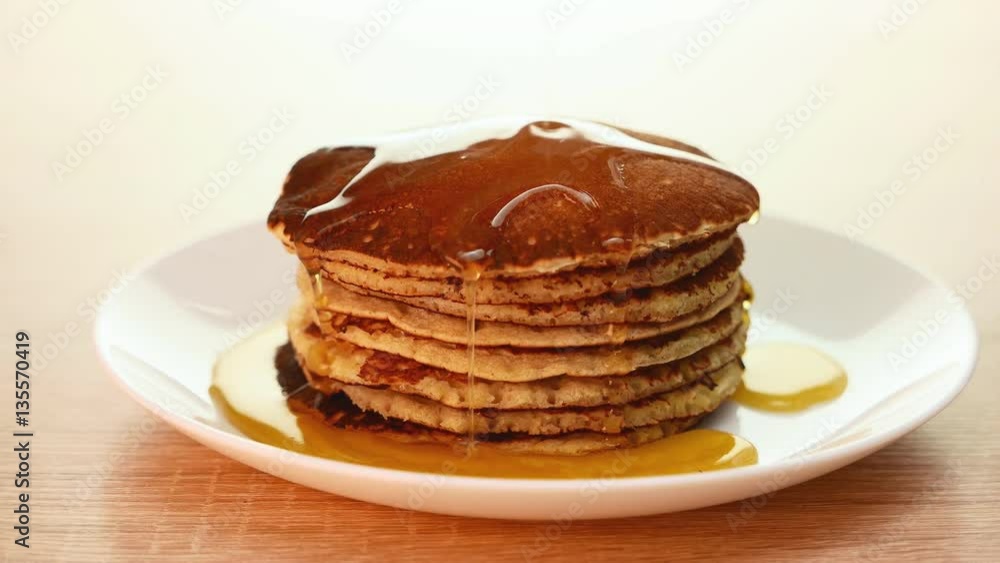 Pancake in a dish, poured stream of honey Pancake in a dish, poured stream of honey