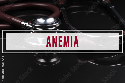 фотографія Stethoscope on black background with text ANEMIA