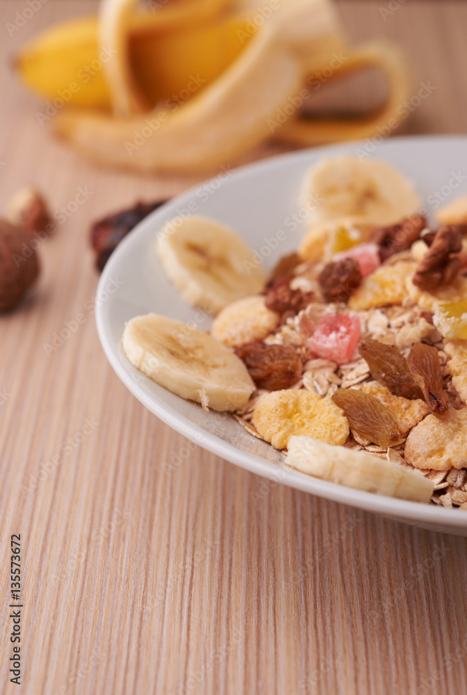 flakes with dried fruit, granola on the plate flakes with dried fruit, granola on the plate