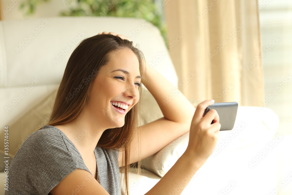 Girl watching streaming video in a smart phone Girl watching streaming video in a smart phone