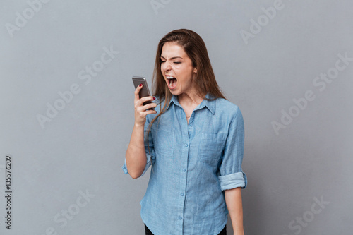 Woman in shirt screaming on phone