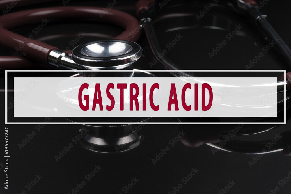 Obraz premium Stethoscope on black background with text GASTRIC ACID