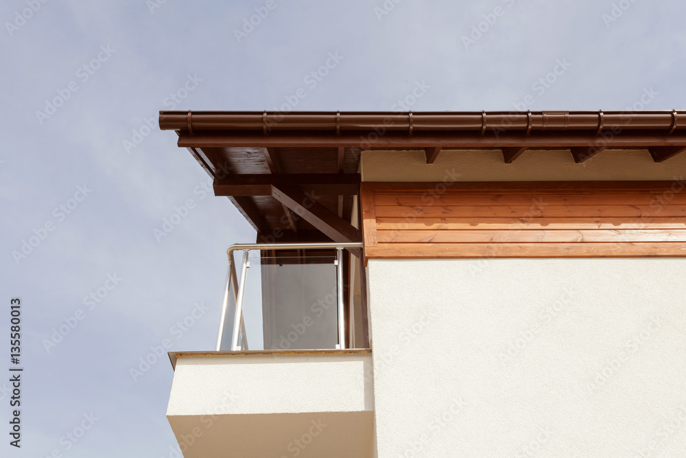 New house with brown rain gutter, white wall and balcony New house with brown rain gutter, white wall and balcony