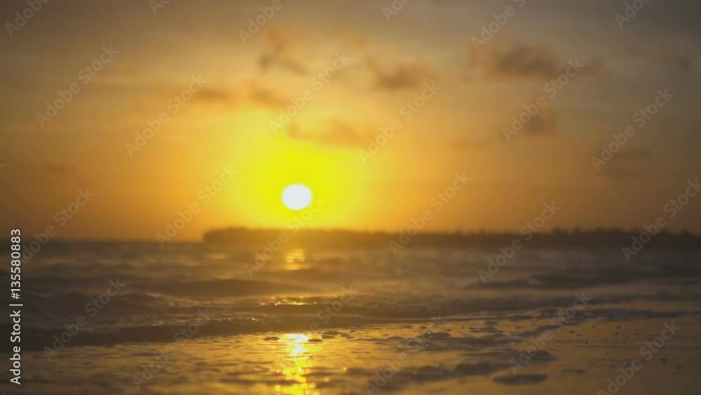 Water on the beach in the rays of the setting sun close-up Water on the beach in the rays of the setting sun close-up