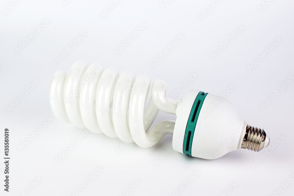 Energy saving light bulb with green line on a white background. Energy saving light bulb with green line on a white background.