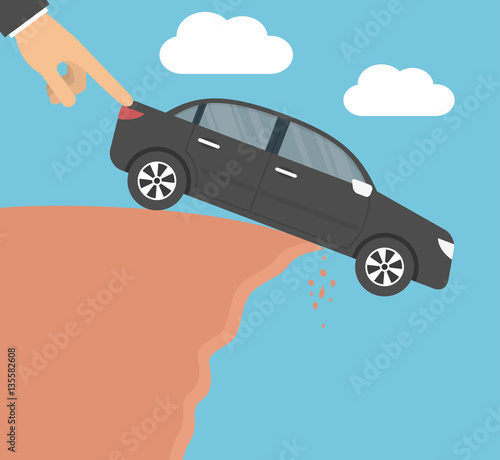 Hand pushing a car down from a cliff