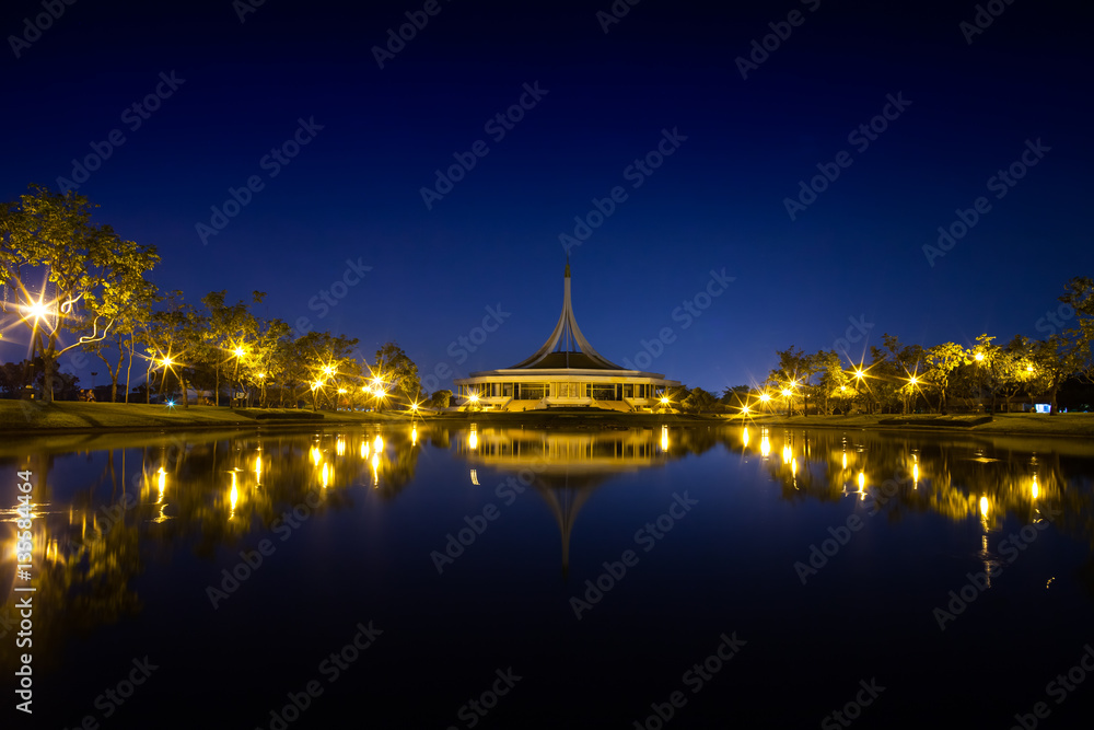 Night garden with central building landscape view reflection on water at twilight time , the garden is located at bangkok thailand