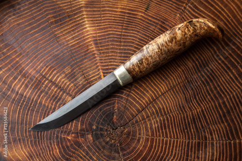 Fototapeta Naklejka Na Ścianę i Meble -  Knife on a wooden textured surface