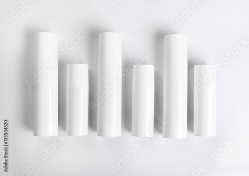 Blank cosmetic tubes on white background. White and silver color