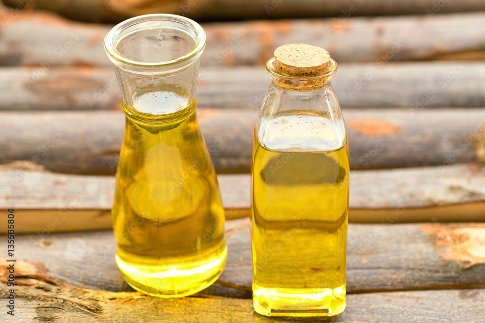Olive oil in a bottle on wooden table. Olive oil in a bottle on wooden table.