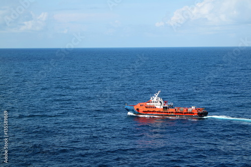 Supply boat transfer cargo to oil and gas industry and moving cargo from the boat to the platform © chanjaok1