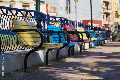 Fotografia Perspective of colored benches in the city park (blurred in distance)
